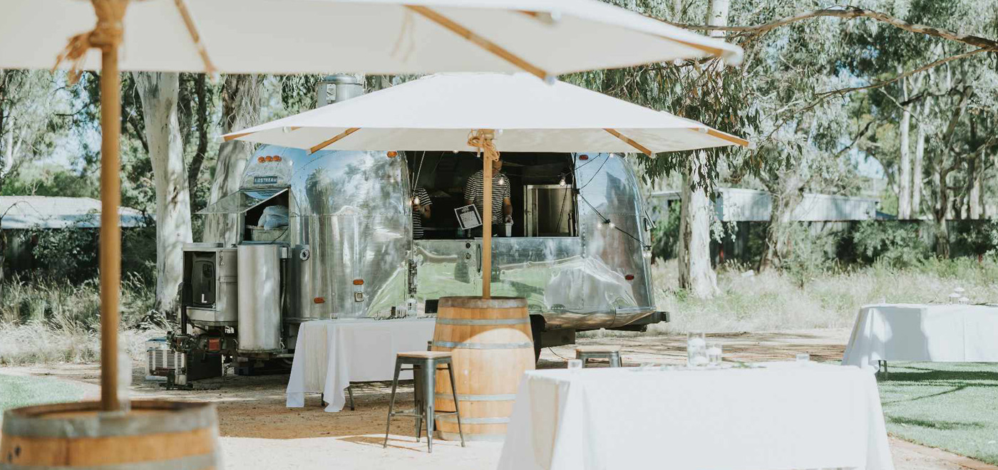 Ultimate cocktail cart and bartender setup with sleek cart, glassware, slushy machine, and bar stools for Melbourne and Bendigo events.